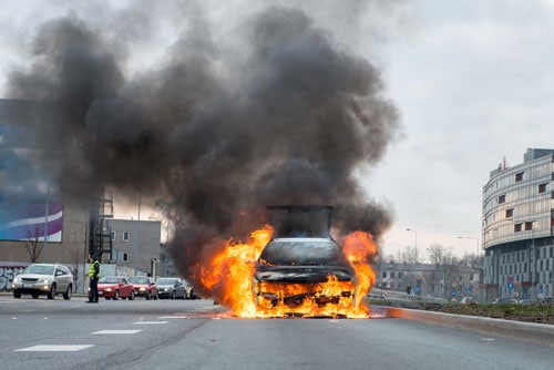 car on fire in the street | Burn Injuries after a Car Accident | Broomfield Burn Injury Attorneys